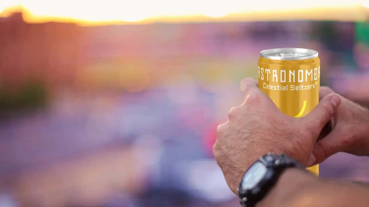 man holding a chilled THC seltzer can