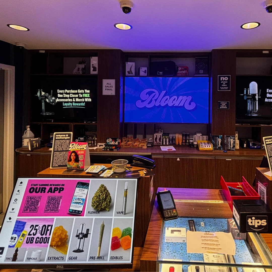 Bloom Painesville dispensary product menu screen displaying the differerent kinds of products you can purchase and accessory wall behind the counter