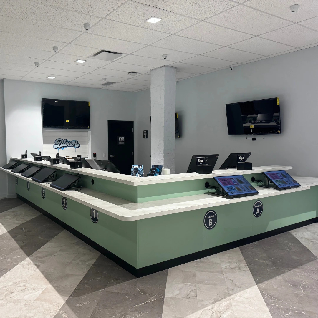 Bloom Athens marijuana dispensary checkout counter with menu screens for medical and recreational product selection