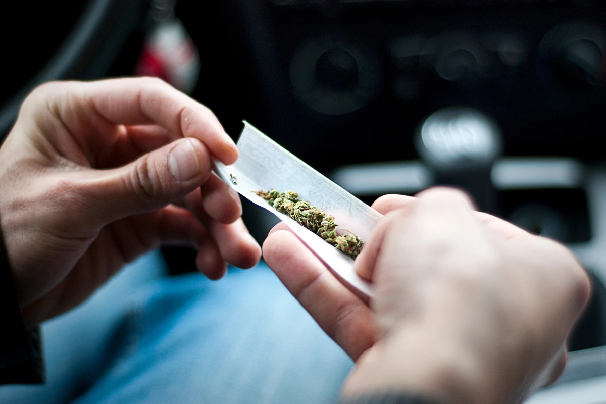Cannabis being prepared inside a vehicle illustrating Ohio cannabis DUI and vehicle possession laws