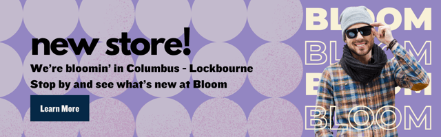 Man in casual attire smiling and adjusting sunglasses. Text: "New store in Columbus - Lockbourne. Stop by and see what’s new at Bloom."